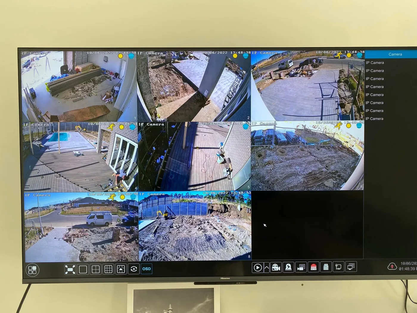 Eight CCTV camera feeds of a home under construction on a TV