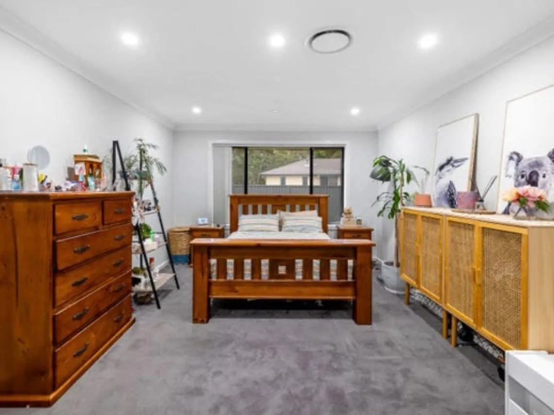 Bedroom with a timber bed and drawers, before the build