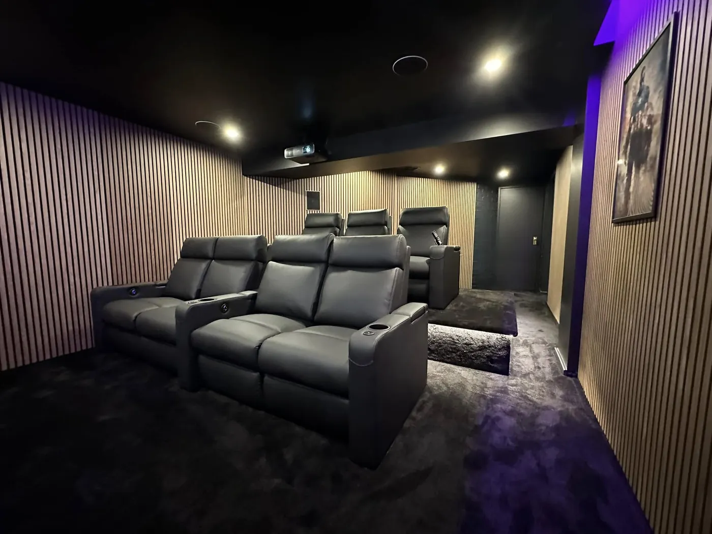 Leather recliners in a cinema room with timber slat walls