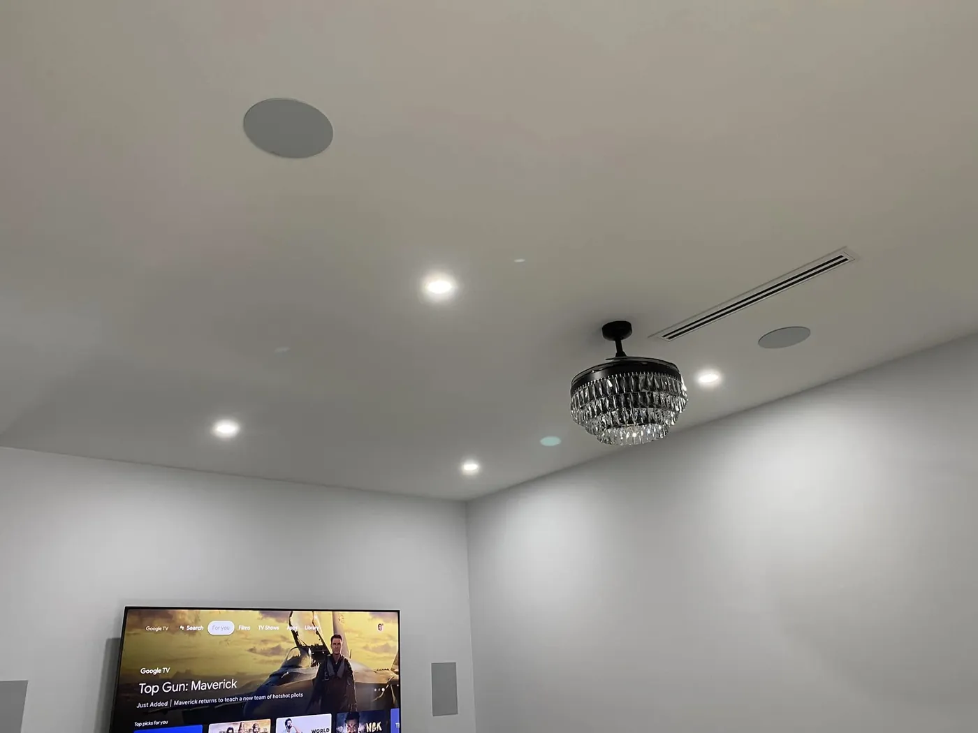 In-ceiling speakers in a living room with a wall-mounted TV