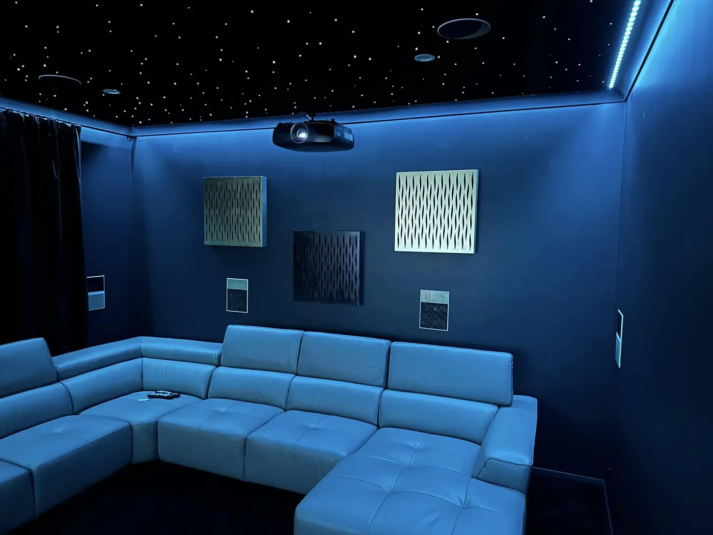 Acoustic panels on the wall of a cinema room with a star-light ceiling