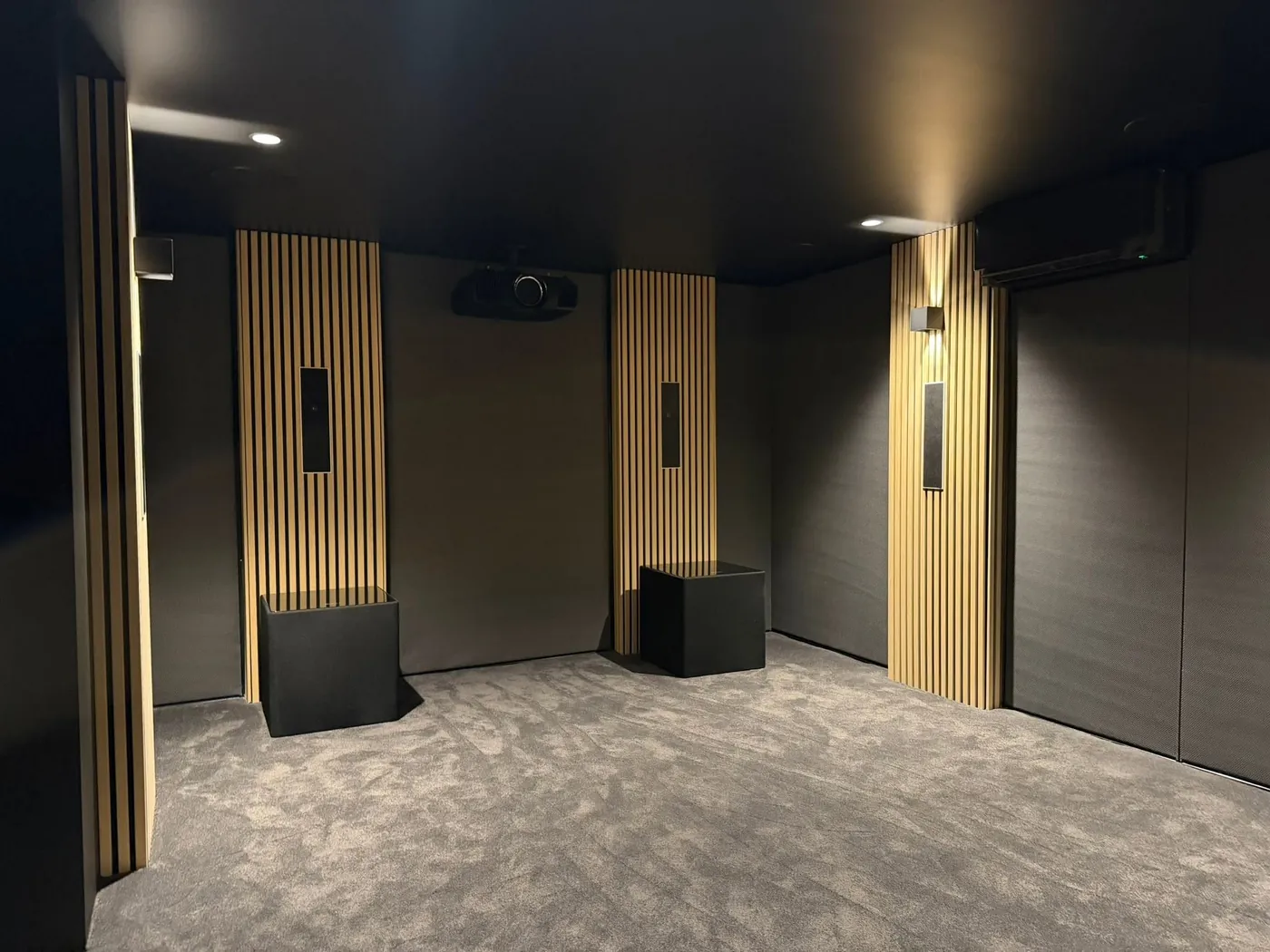 Cinema room with timber slat panels and fabric-lined walls