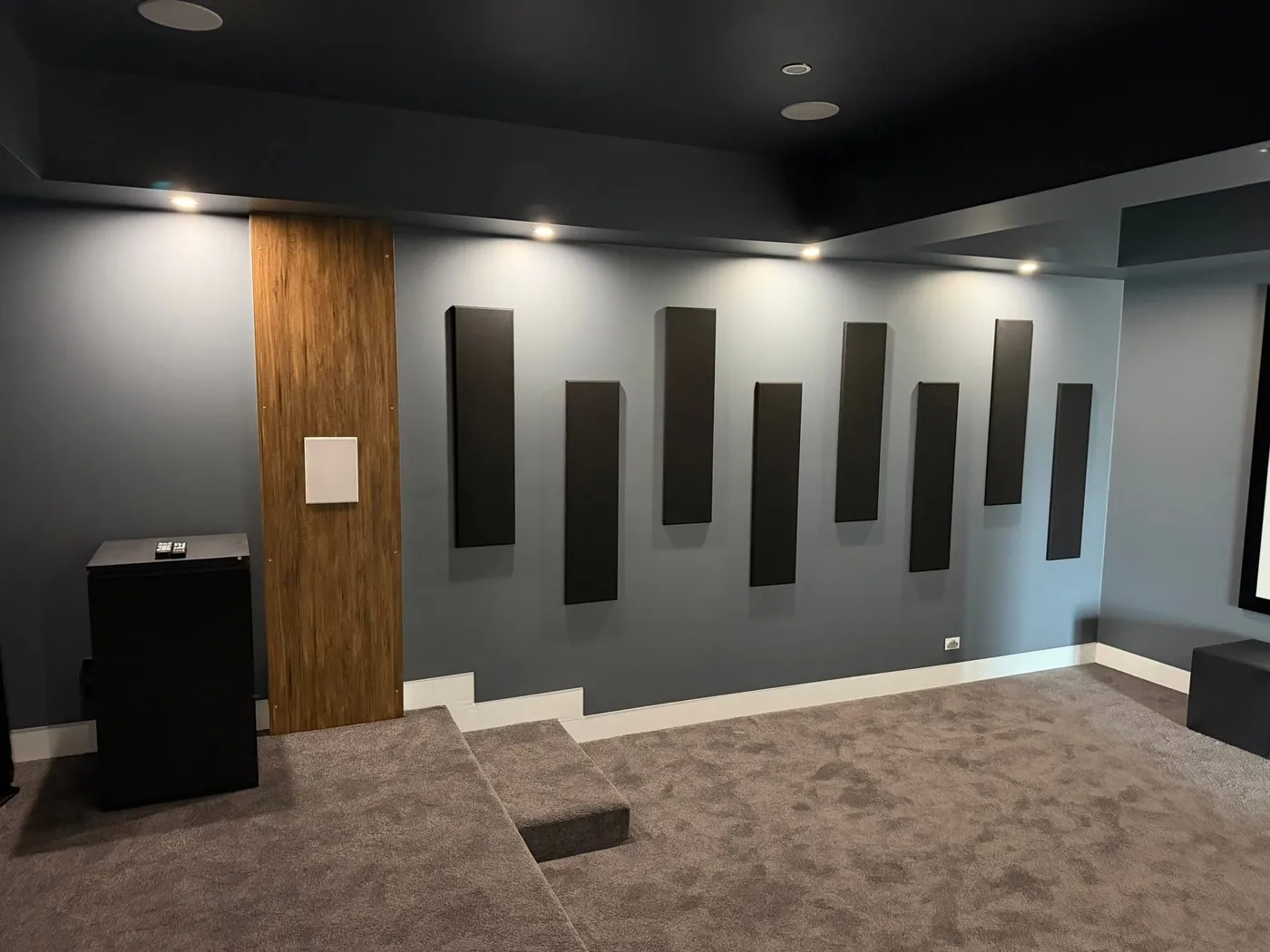 Rectangular acoustic panels arranged across a cinema feature wall